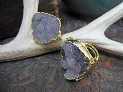 front and side view of light gray druzy rings in gold