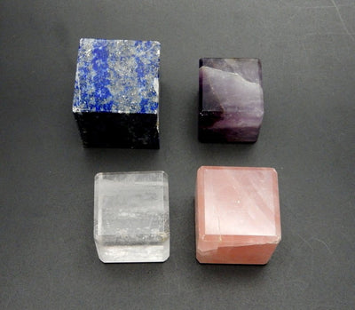 4 different crystal cubes on black background