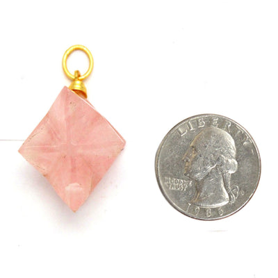Rose Quartz Merkaba Star next to a quarter for size reference on white background