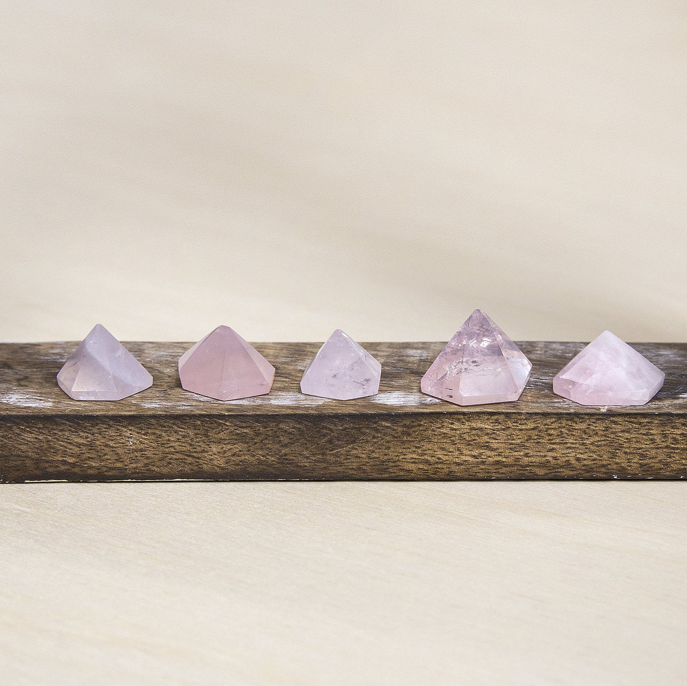 rose quartz Pyramid displayed to show size variations