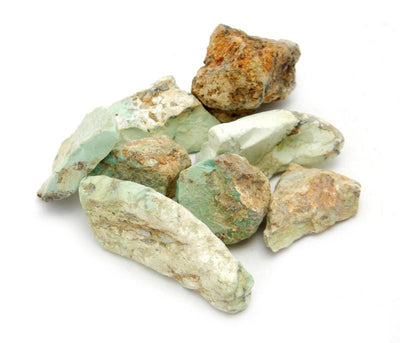 Pile of Rough Natural Apache Turquoise on white background