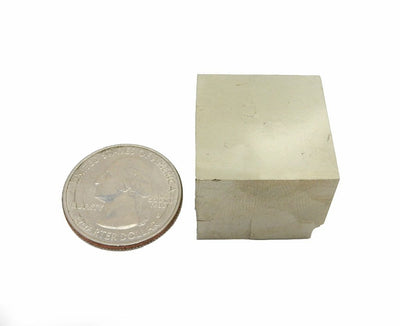 Pyrite Cube next to a quarter
