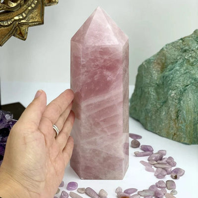 Rose Quartz Polished Point Tower with a hand for size reference
