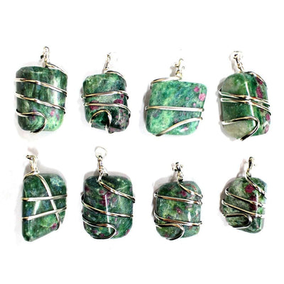 multiple Ruby Fuchsite Tumbled Stone Pendants laid out on white background to show various patterns natural inclusions shades of greens and pinks