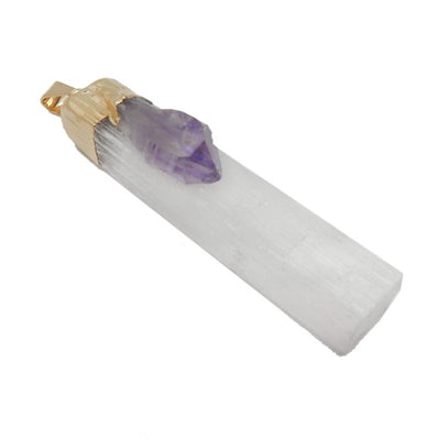 close up of selenite with amethyst gold pendant for details