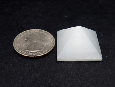 selenite pyramid with quarter for size reference