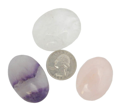 set of three worry stones with quarter for size reference