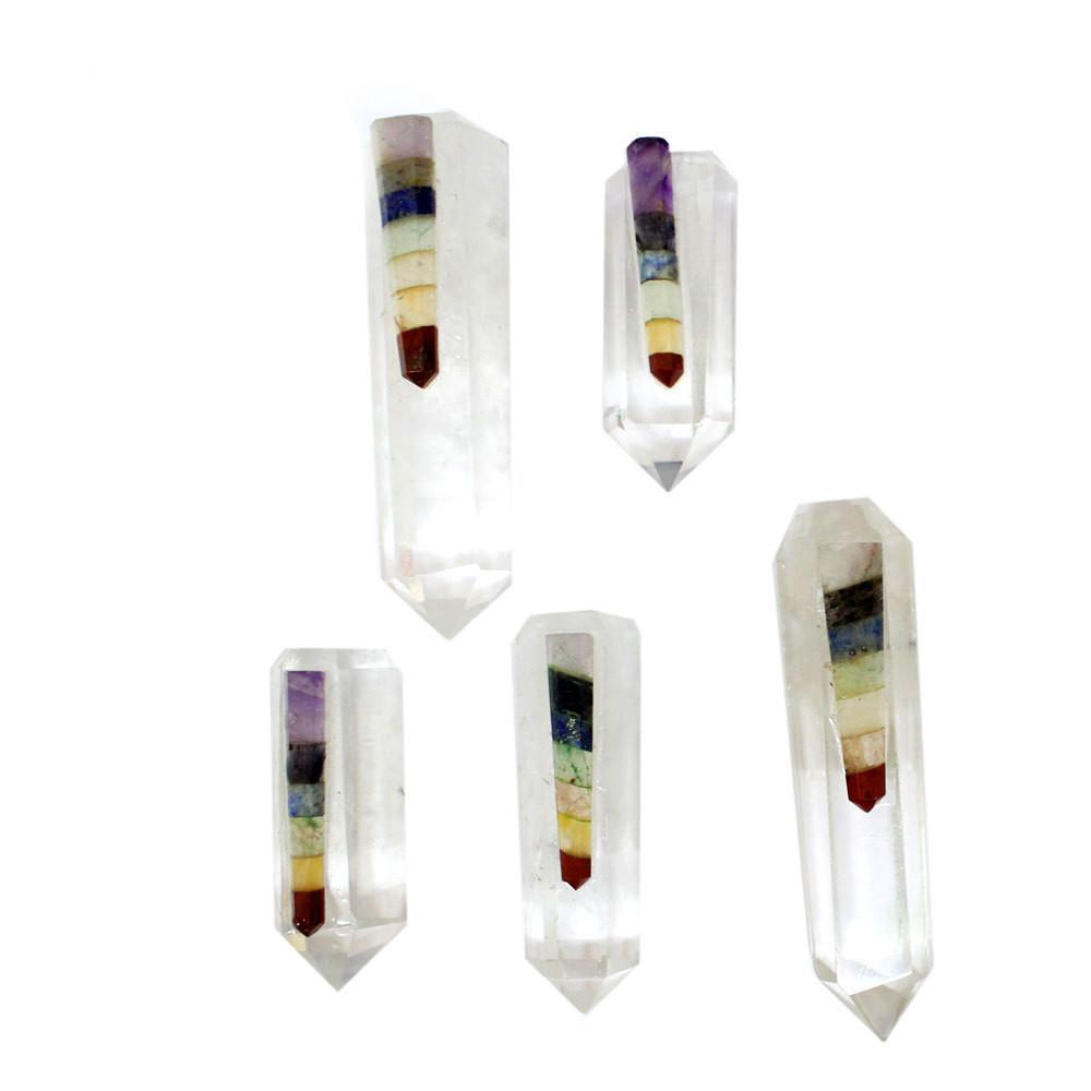 five seven chakra crystal quartz points in front of white backdrop for possible variations