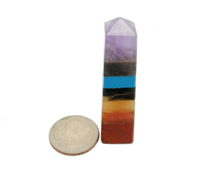 seven chakra crystal tower point with quarter for size reference