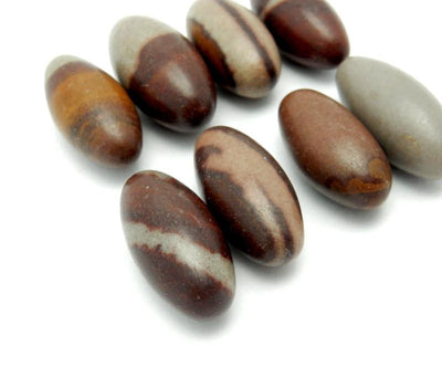 angled view of shiva lingam stones on white background for thickness