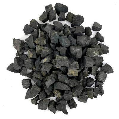 many shungite natural stones in a pile on white background