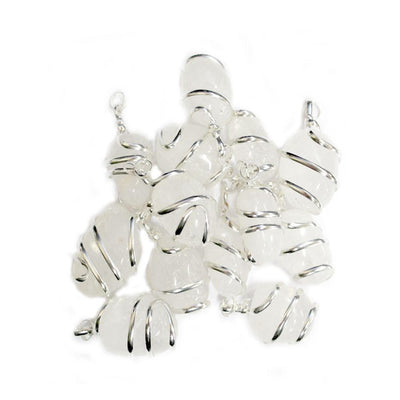 many silver spiral crystal quartz pendants in a pile on white background for possible variations