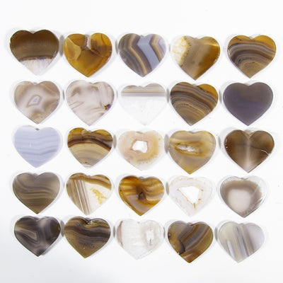 Multiple Agate Heart Shaped Cabochons displayed on a white background to display color and pattern variation.