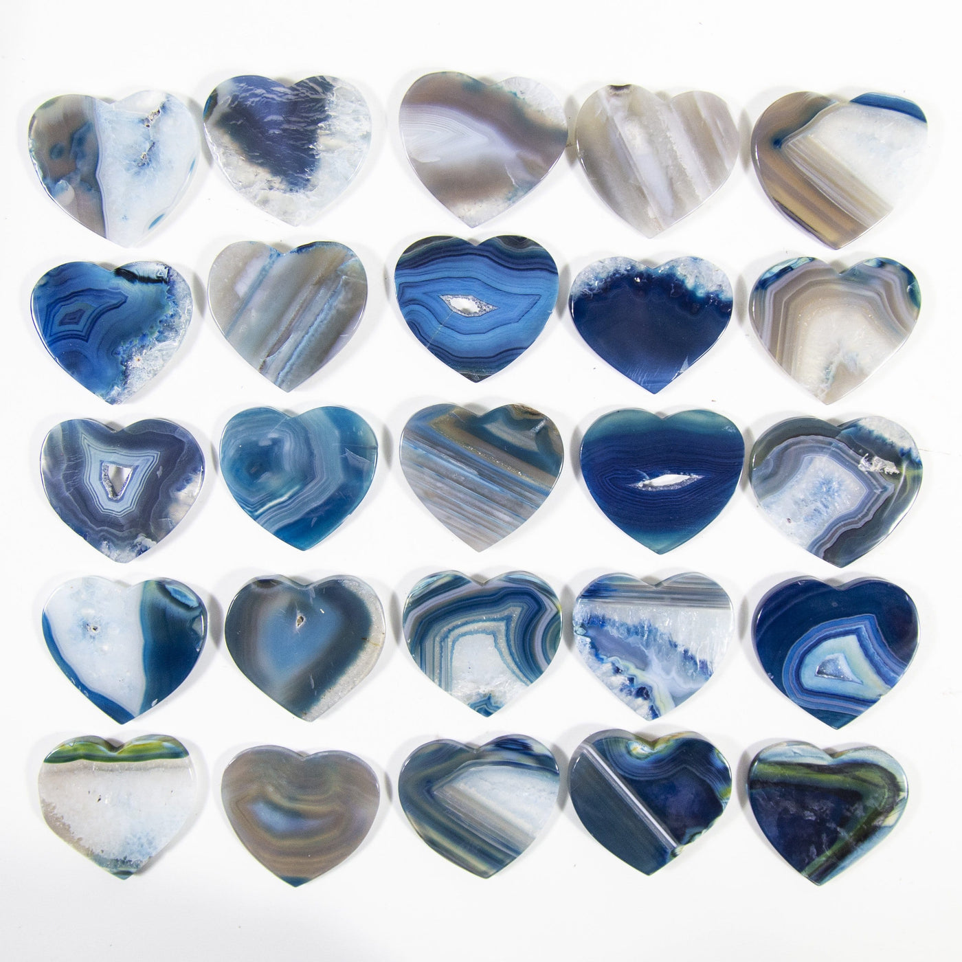 Multiple blue agate Heart Shaped Cabochons displayed on a white background to display color and pattern variation.