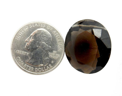 one smokey quartz bead with quarter on white background for size reference