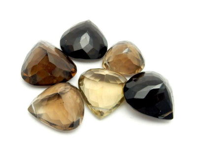 many smokey quartz beads in a pile on white background for possible variations