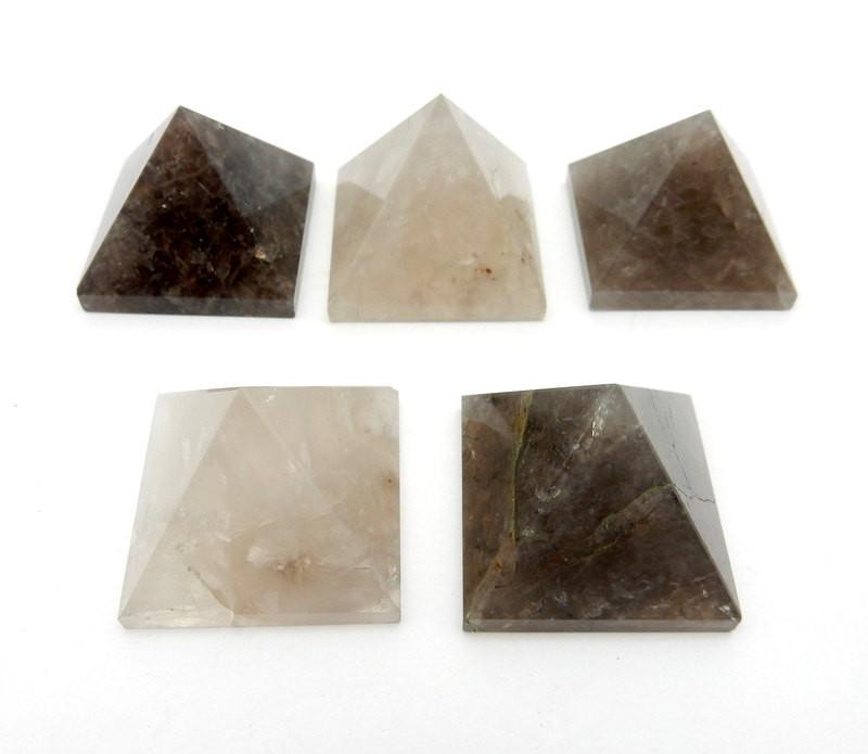 five smokey quartz pyramids on white background for possible variations