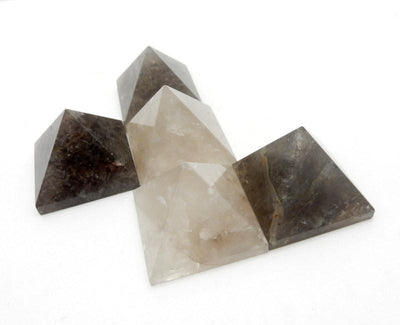 five smokey quartz pyramids on white background for possible variations