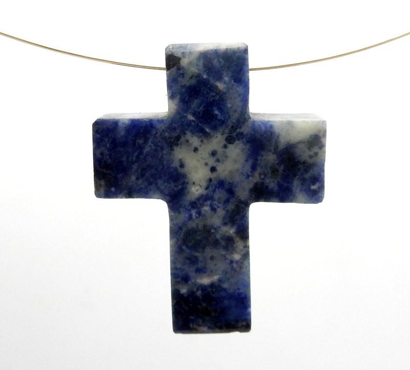 close up of one sodalite cross with wire running through side drill over white background