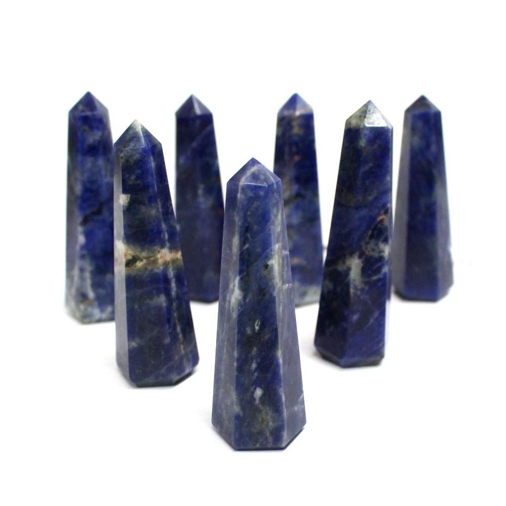 many sodalite crystal towers on display on white background for possible variations
