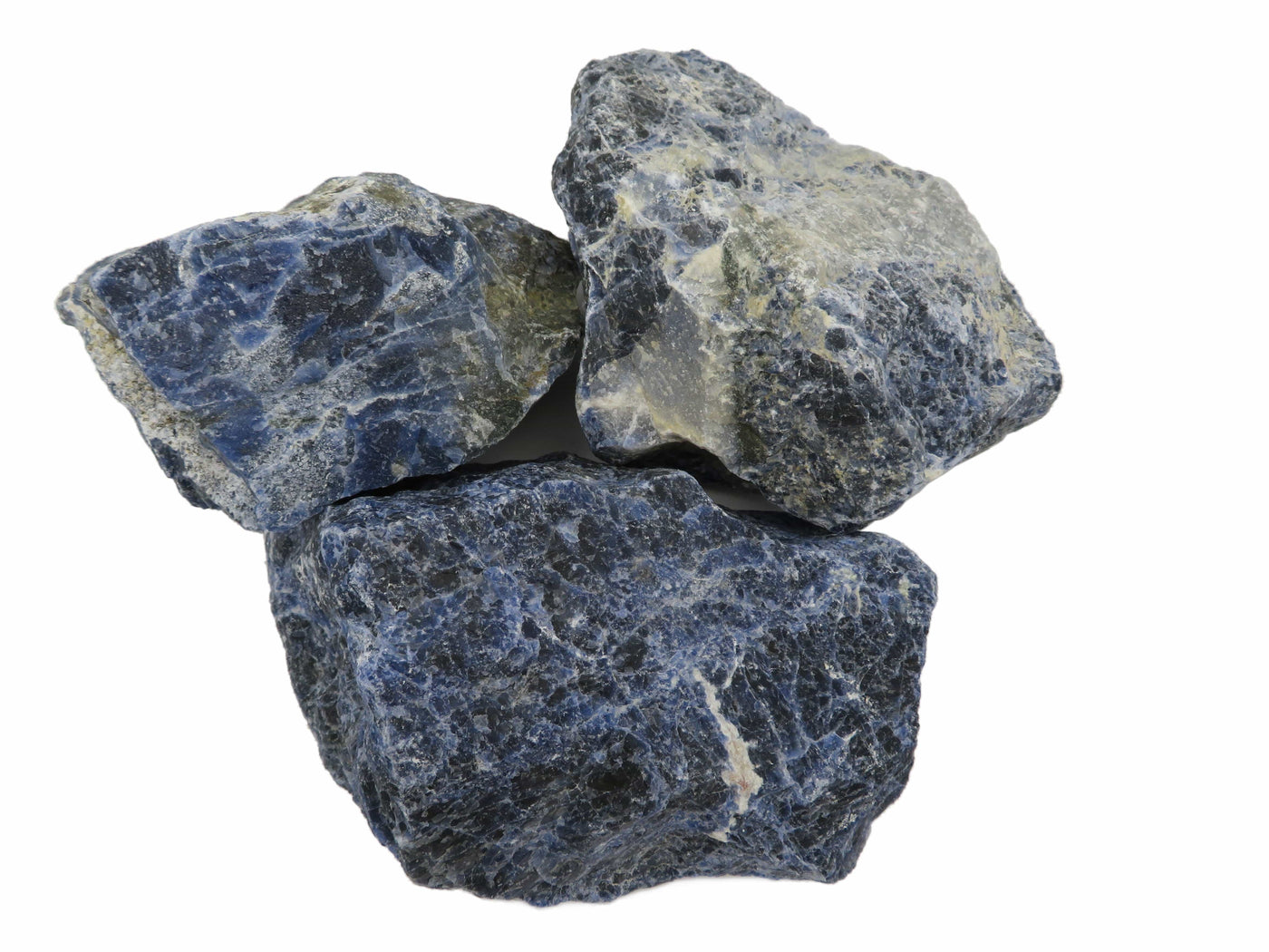 three sodalite rough stones on white background for possible variations