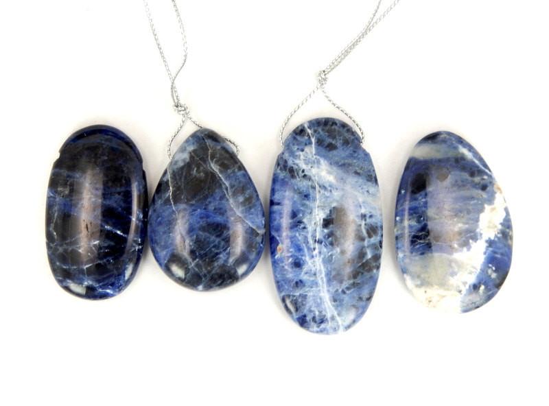 multiple sodalite top drilled beads displayed to show the differences in the color shades and sizes 