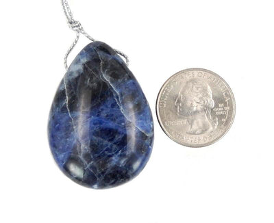 sodalite bead next to a quarter for size reference 