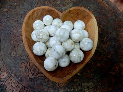 wooden heart bowl filled with Cobra Skin Agate Sphere Balls 