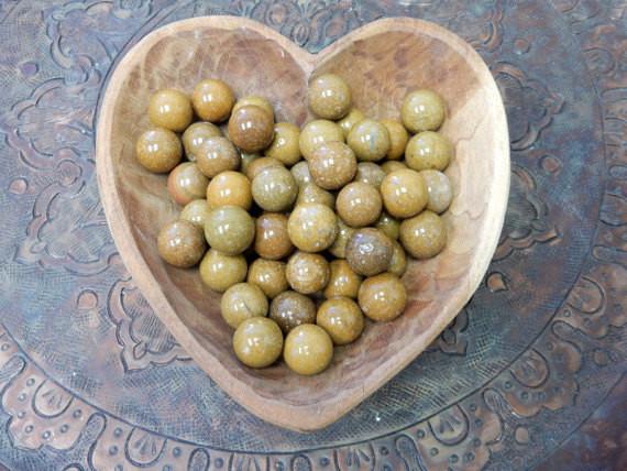 yellow jasper spheres in a wooden heart bowl