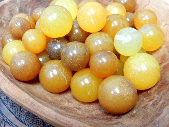 a pile of Yellow Onyx Spheres Petite Size