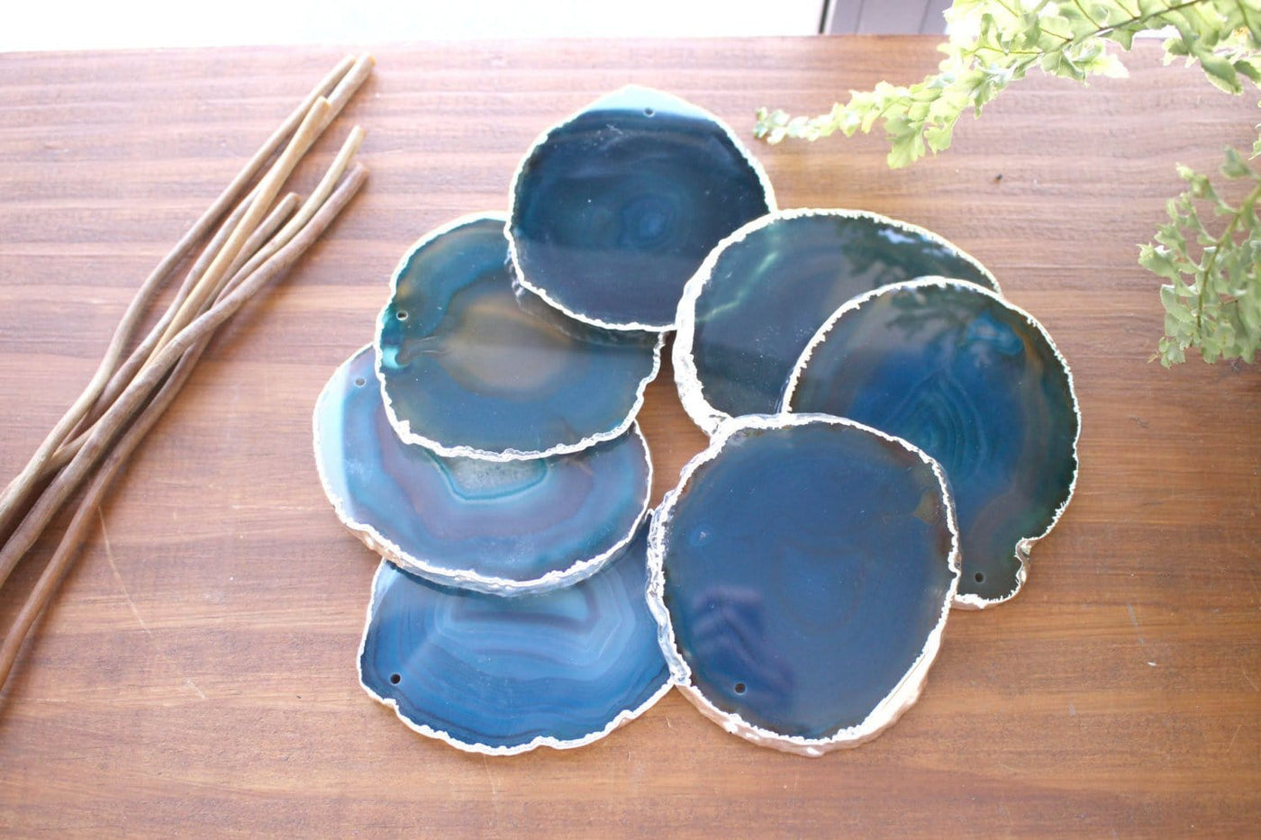 A circle of  silver electroplated Teal Top Drilled Agate Slices . Those agate slices measure between 3-3.5" in diameter. and have an average weight of 0.15 lb