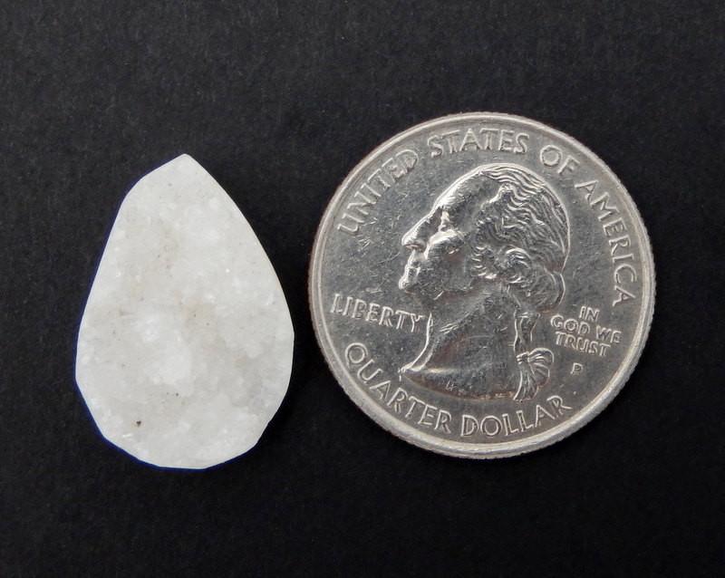 A White Teardrop Druzy Bead Next to a quarter for sizing , Measures approx. 19-24mm x 13-16mm