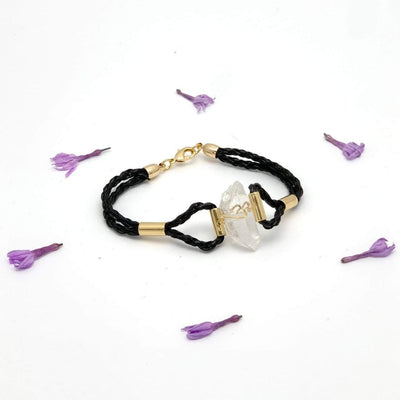 crystal quartz leather bracelet on white background