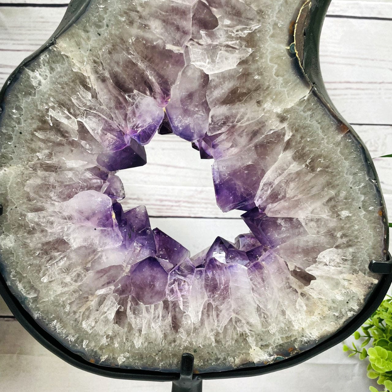 Amethyst Slice in shape of 8 on Metal Stand up close