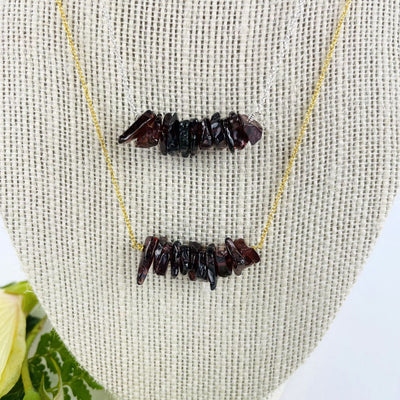 Garnet Stone Necklace on a bust showing gold and silver chain up close