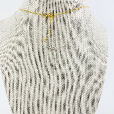 Necklace on a bust showing gold and silver chain clasps 