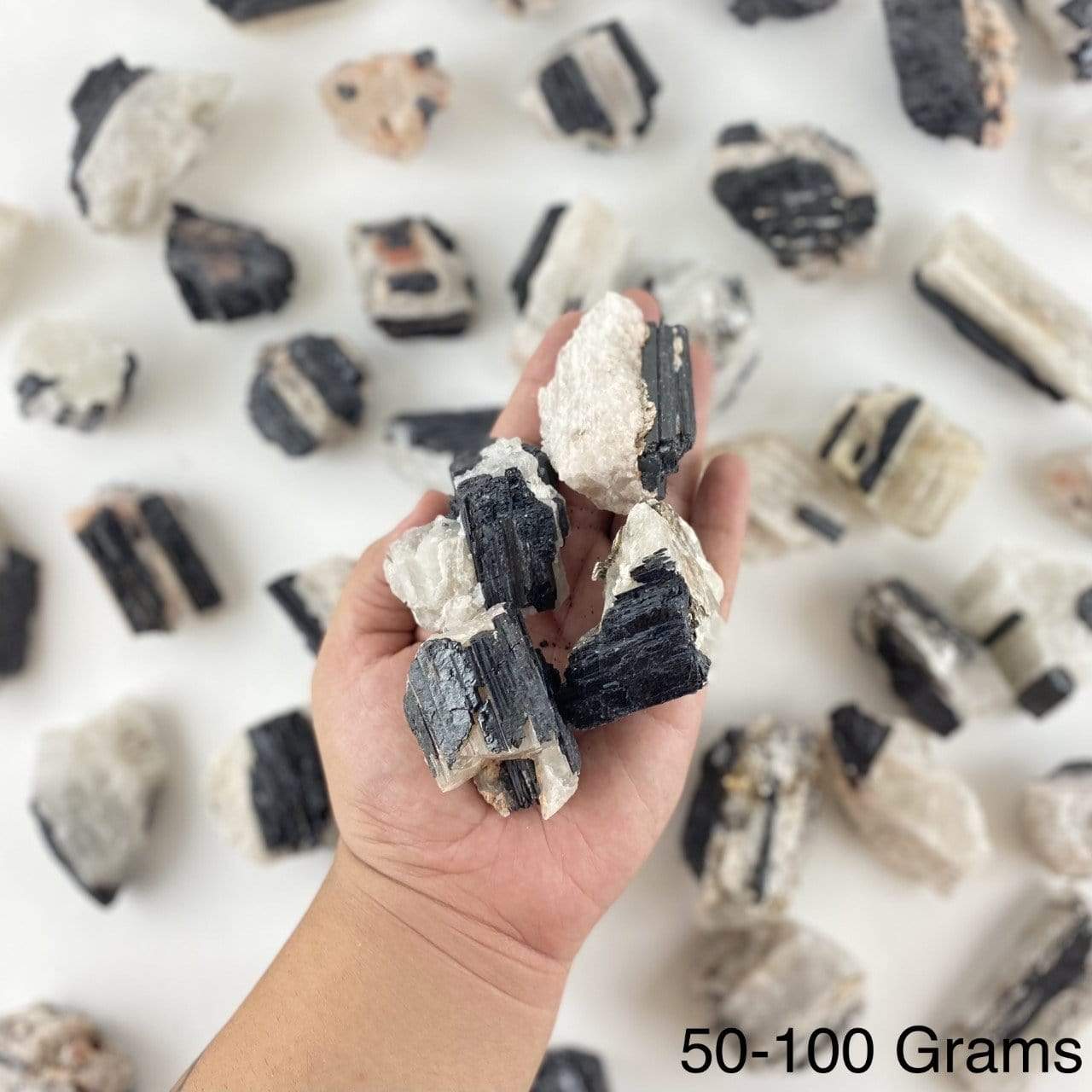black tourmaline on matrix displayed in hand size is for 50-100 grams