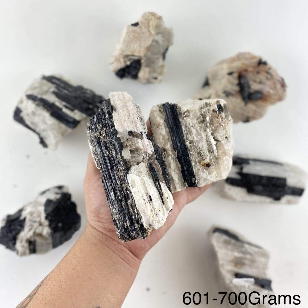 black tourmaline on matrix displayed in hand size is for 601-700 grams