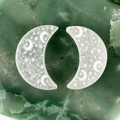two selenite engraved crescent moon charging plates on display for engraving variations