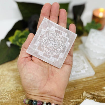 selenite shri yantra mandala engraved square charging plate in hand for size reference