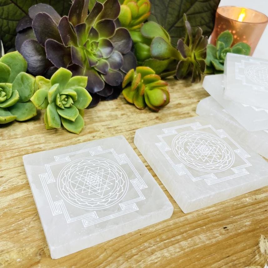 angled view of selenite shri yantra mandala engraved square charging plate for approximate thickness