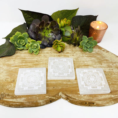 selenite shri yantra mandala engraved square charging plates on display for approximate thickness and possible variations