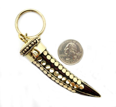 a Tibetan Style Keychain Horn with Brown Mosaic next to a quarter for sizing 
