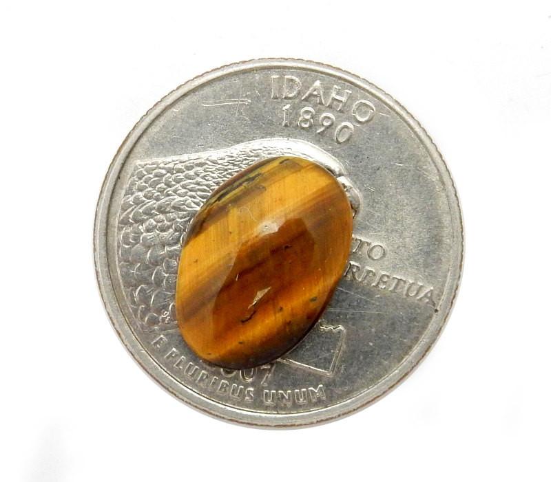 tigers eye cabochon with a quarter for size reference