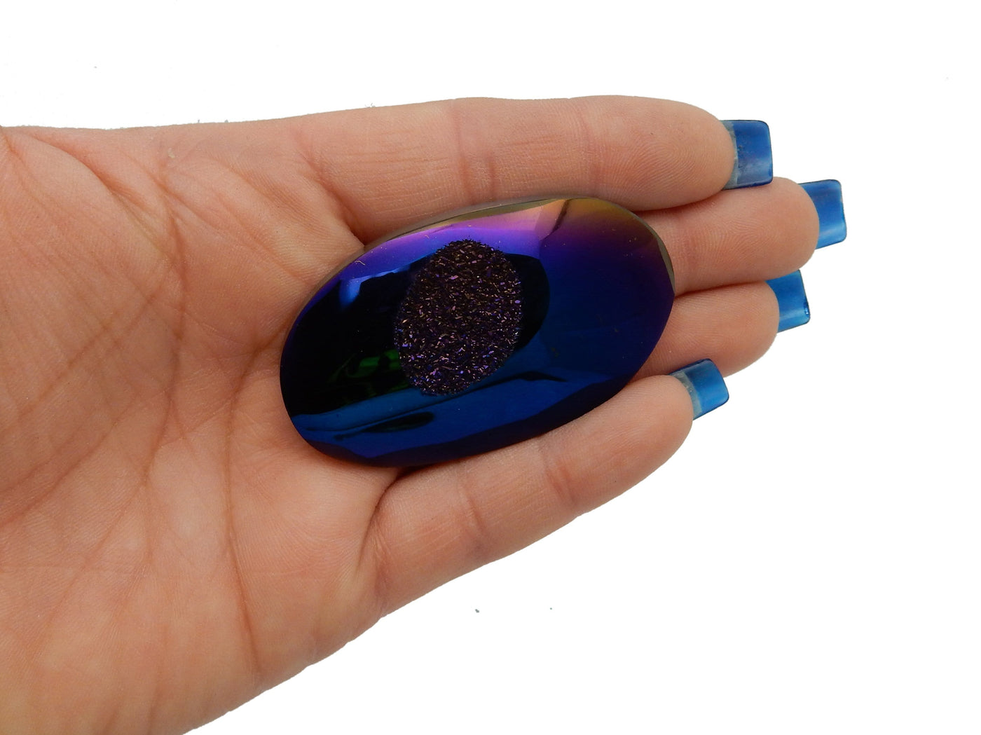 Mystic Blue Titanium Druzy Oval Cabachon, shown in hand for size reference