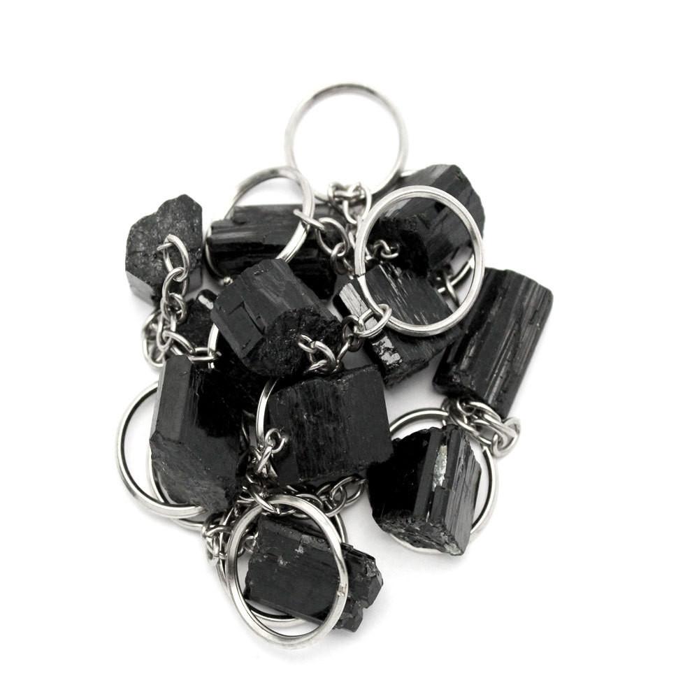 A pile of Tourmaline Stone Silver Toned Key Chains