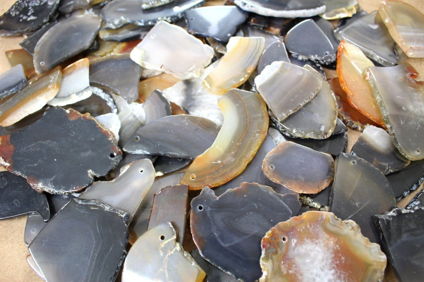 assorted tumbled natural drilled agates.