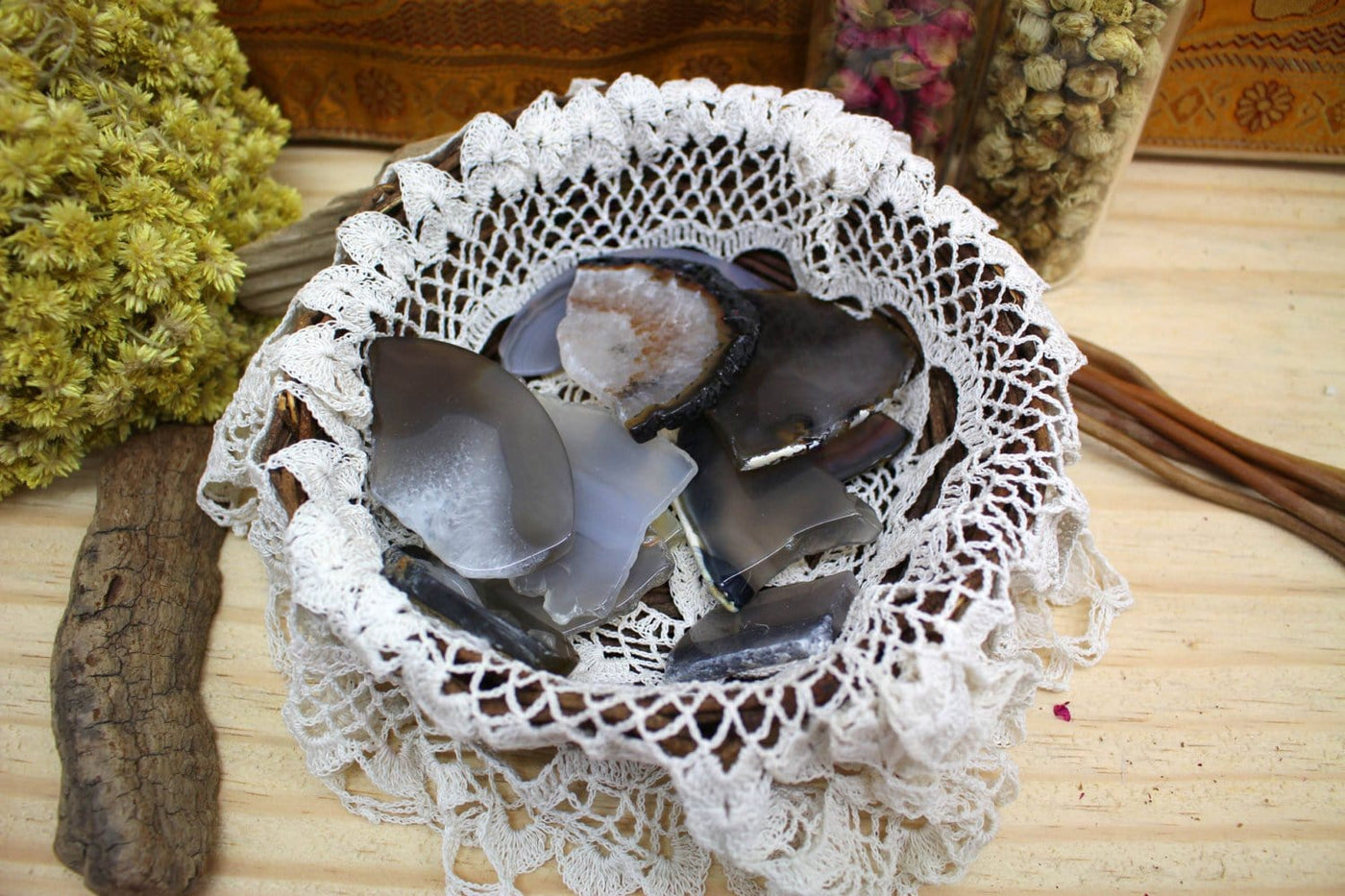 Tumbled Agate Slices in a wooden bowl with a cloth.