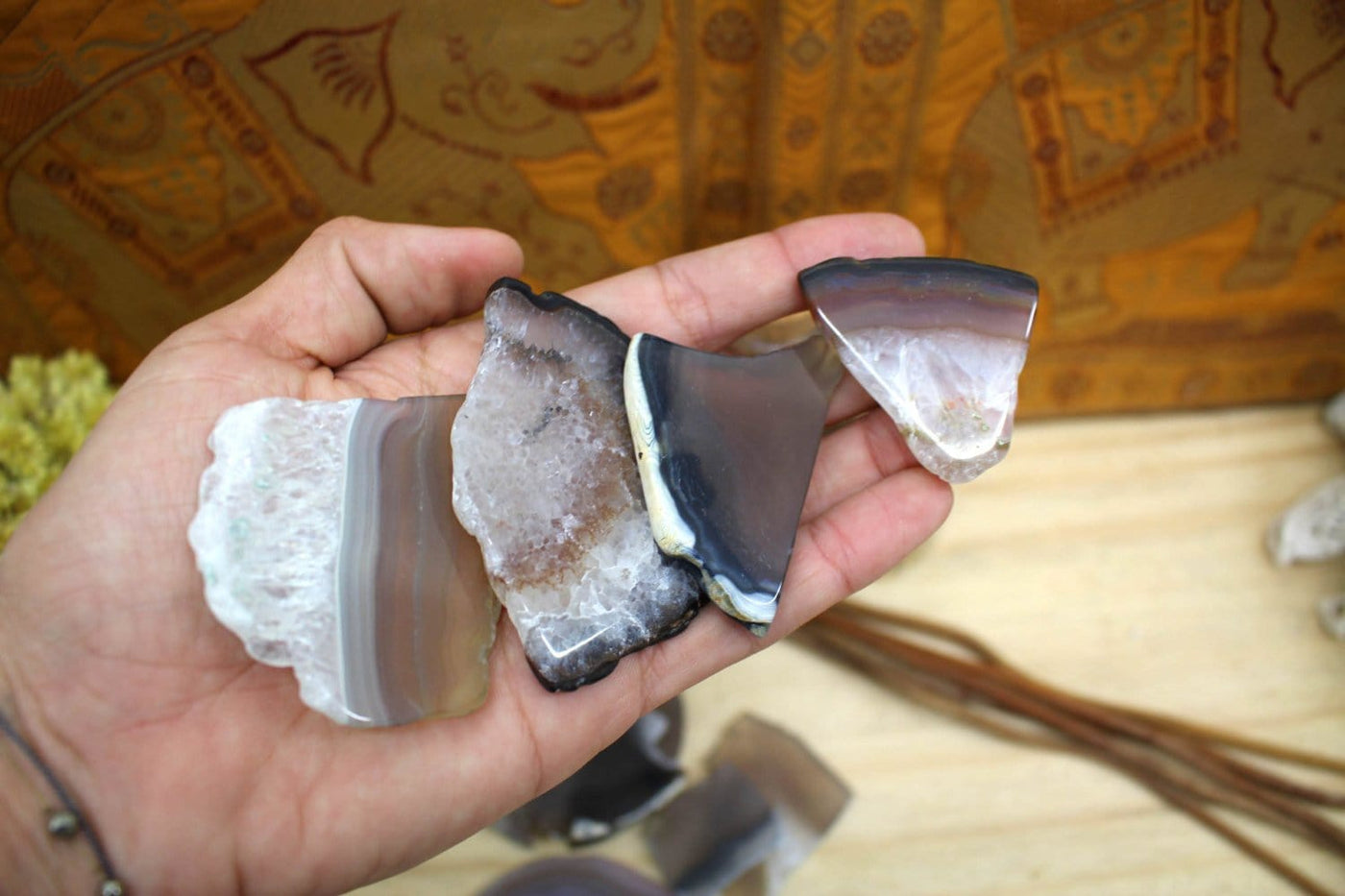 4 Tumbled Agate Slices held in a palm