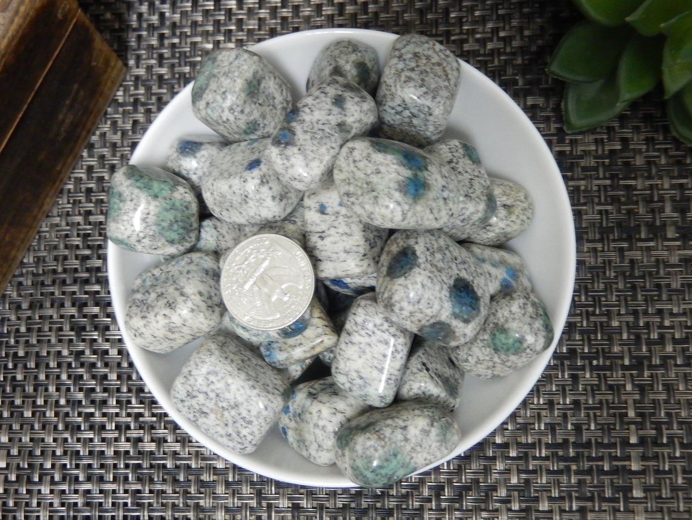 granite/jasper tumbled stones in a bowl with a quarter for size reference